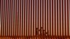 Migrantes que intentan llegar a Estados Unidos caminan junto a un muro fronterizo en Ciudad Juárez, México, visto desde El Paso, EEUU, el 8 de mayo de 2023.