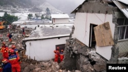 Rescue workers search for survivors near damaged houses after a landslide hit Liangshui village in Zhenxiong county of Zhaotong, Yunnan province, China, Jan. 23, 2024. (cnsphoto via Reuters)