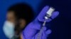 FILE - A nurse practitioner prepares a syringe with the mpox vaccine before inoculating a patient at a vaccination site in New York City, Aug. 30, 2022 The U.K. has three confirmed cases of mpox variant clade 1b, as of Nov. 5, 2024.
