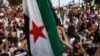 FILE - A girl raises the Syrian opposition flag in Idlib, Aug. 25, 2023, in support of anti-government protests in the southern city of Sweida. More protests occurred March 1, 2024, across Syria's northwest against that region's jihadi rulers.