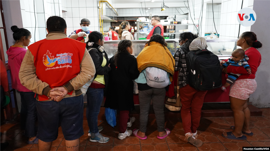 Venezolanos hacen fila paras recibir comida en la sede de la Asociación Obras del Espíritu Santo, en San José, Costa Rica.