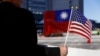 Seorang demonstran memegang bendera Taiwan dan Amerika Serikat untuk mendukung Taiwan di Burlingame, California, 14 Januari 2017. (Foto: Reuters)
