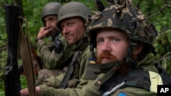 Ukrainian servicemen take rest in a recently retaken village north of Kharkiv, east Ukraine, May 15, 2022