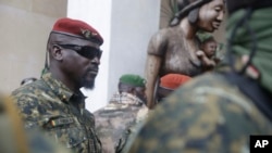 FILE - Guinea junta leader Mamady Doumbouya, leaves a meeting with an ECOWAS delegation in Conakry, Guinea, Sept. 10, 2021. Coup leaders on Saturday announced a ban on political protests in the country.