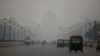 India's Rashtrapati Bhawan, or the Presidential Palace is partly visible due to smog as traffic plies on Rajapth, the ceremonial boulevard in New Delhi, India, Nov. 1, 2018.