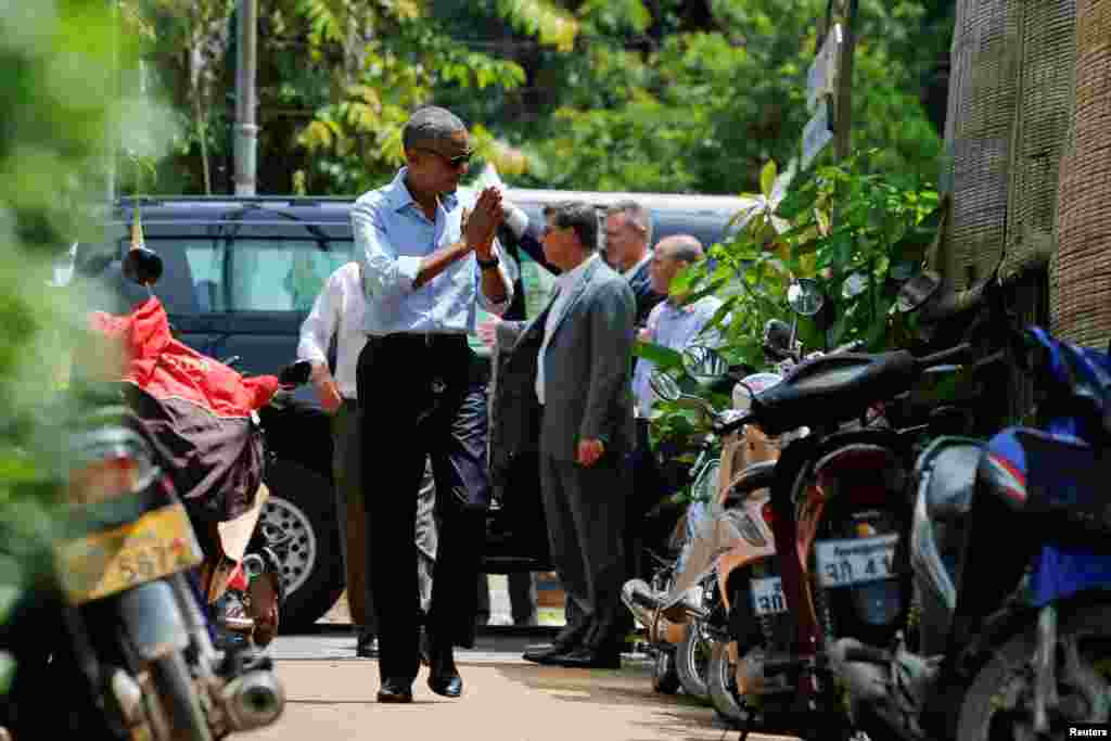 Presiden AS Barack Obama menyapa warga lokal sat berjalan kaki di Luang Prabang (7/9).&nbsp;(Reuters/Jonathan Ernst)