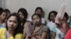FILE - A community health worker holds up contraceptives during a lecture on family planning at a reproductive health clinic run by an NGO in Tondo city, metro Manila, Jan. 12, 2016.