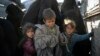 Women and children exit the back of a truck as they arrive at a U.S.-backed Syrian Democratic Forces (SDF) screening area after being evacuated out of the last territory held by Islamic State militants, in the desert outside Baghuz, Syria, March 1, 2019. 