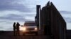 FILE - United States Border Patrol agents stand by a vehicle near one of the border walls separating Tijuana, Mexico and San Diego, in San Diego, Nov. 21, 2018.