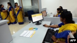 An all-female bank staff are pictured at their terminals during the inauguration of the first branch of the Bharatiya Mahila Bank (BMB), India's first state owned women's bank, in Mumbai, Nov. 19, 2013.