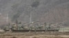 South Korean army soldiers stand on their K-55 self-propelled howitzers during an annual exercise in Paju, near the border with North Korea, Monday, March 7, 2016.
