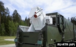 A Russian military truck with a laser weapon mounted on it is shown at an undisclosed location in Russia.