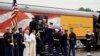 The flag-draped casket of former President George H.W. Bush is carried by a joint services military honor guard as it is placed on a Union Pacific train in Spring, Texas, Dec. 6, 2018. 