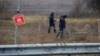 Ukrainian mine experts scan for unexploded ordnance and landmines by the main road to Kherson, Ukraine, Nov. 16, 2022.