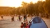 FILE - A Syrian family is seen in a tent on the beach at Menekse in Istanbul at sunset on July 28, 2019. 