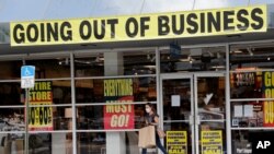 FILE - A customer leaves a Pier 1 retail store, which is going out of business, during the coronavirus pandemic in Coral Gables, Florida, Aug. 6, 2020.