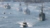 FILE - Royal Australian Navy warships led by HMAS Sydney (R) enter Sydney Harbor as part of the International Fleet Review celebrations October 4, 2013. 