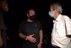 El actor cubano Jorge Perugorría, centro, y el director de cine Fernando Pérez (der.) dialogan mientras participa en una manifestación para ayudar al diálogo entre los jóvenes artistas que protestaron frente a las puertas del Ministerio de Cultura.