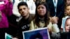 FILE - Dreamer Karen Caudillo, 21, of Florida is comforted by Jairo Reyes, 25, of Rogers, Ark., as Sen. Kamala Harris, D-Calif., accompanied by fellow congressional Democrats, speaks during a news conference on Capitol Hill in Washington, Sept. 6,