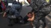 Armenian police officers detain a protester during a rally against land transfer to Azerbaijan, in Yerevan on April 27, 2024.