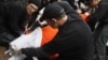 Protesters perform a simulation of the waterboarding torture technique on a man dressed as a prisoner during a protest, marking the fifth anniversary of the U.S.-led invasion of Iraq, in front of the White House in Washington, March 19, 2008. 