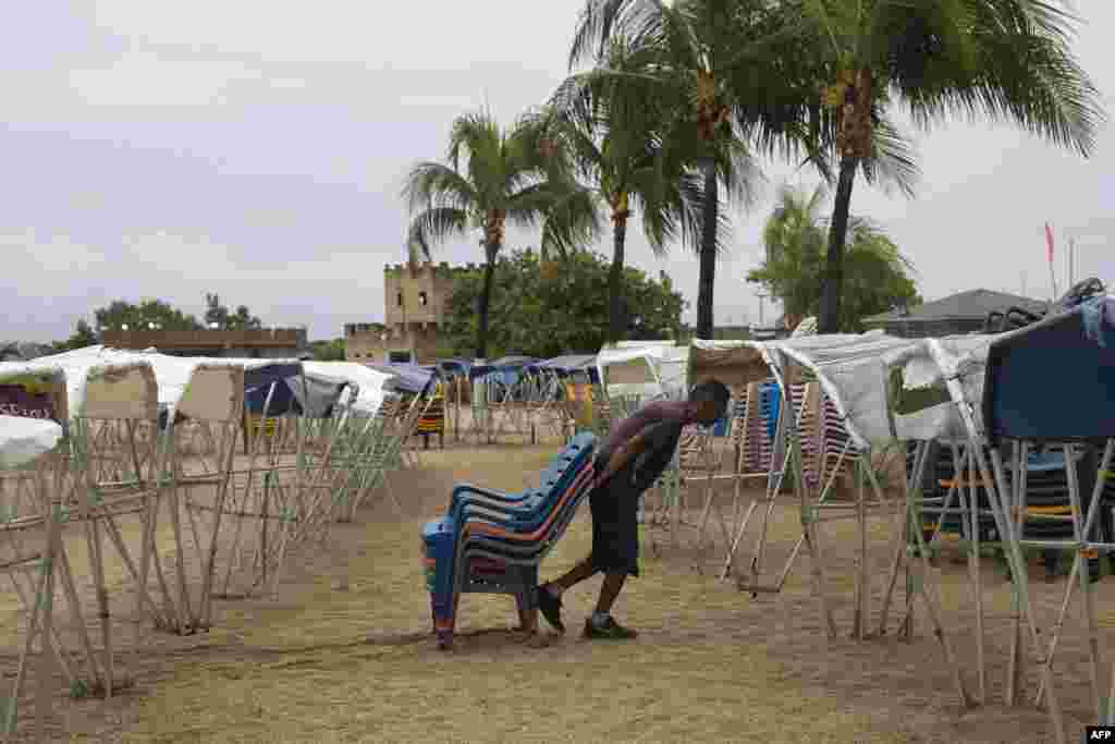 Un hombre carga sillas en una playa vacía en la ciudad venezolana de La Guaira.