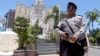 A police officers stands at the memorial of the 2002 Bali bombing site in Bali, Indonesia, Jan. 15, 2016. 