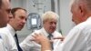Britain's Prime Minister Boris Johnson, center, visit Pilgrim Hospital in Boston, northeast England, Aug. 5, 2019.