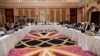 FILE - This photo released by Qatar's Ministry of Foreign Affairs shows Qatari, U.S. and Taliban officials conferring in an undisclosed place in Doha, Feb. 25, 2019.