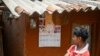 FILE - A boy looks at a calendar with a portrait of India's Prime Minister Narendra Modi in Tatem village some 43 Km (27 miles) from Dantewada town in Chhattisgarh state on April 16, 2024.