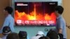 FILE - People watch a TV news program showing an image of North Korea's latest test launch of an intercontinental ballistic missile at the Seoul Railway Station in Seoul, South Korea, July 29, 2017.