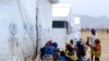 FILE - FILE - Nigerian refugees sit by a UNHCR tent in the refugee camp of Minawao, on the border of Nigeria at the extreme north of Cameroon.