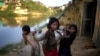 FILE - Rohingya girls carry water pots at Kutupalong refugee camp in Bangladesh, Nov. 19, 2017. Women and girls in this and other camps are often targets of traffickers.
