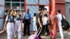 Students arrive to attend classes on a hot summer day, at a school in Dhaka on April 28, 2024, amid the ongoing heatwave.