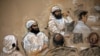 In this courtroom sketch, alleged 9/11 co-conspirators, left, sit with their legal teams during a hearing in the Camp Justice compound for the U.S. war crimes commission on Guantanamo Bay U.S. Naval Base in Cuba, July 16, 2009. 
