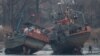 A cargo boat (R) is seen on the bank of the Yalu River in Sinuiju, opposite the Chinese border city of Dandong, March 14, 2016.