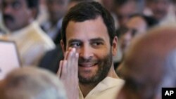 Congress party leader Rahul Gandhi greets attends the swearing-in ceremony for the new ministers in New Delhi, India, October 28, 2012. 