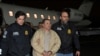 Mexico's top drug lord Joaquin "El Chapo" Guzman is escorted as he arrives at Long Island MacArthur airport in New York, Jan. 19, 2017, following his extradition from Mexico.