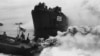 FILE - On the approach of Japanese planes over Okinawa, LCVPs, equipped with smoke pots, lay down a protective smoke screen over the anchorage area.