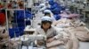 FILE - North Korean employees, shown in December 2013, sew in a South Korean-owned company at the Kaesong industrial park just north of the demilitarized zone. 