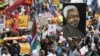 FILE - Demonstrators carry placards during a march against xenophobia in downtown Johannesburg, April 23, 2015.