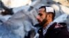 A wounded Palestinian man looks on at the site of an Israeli strike in Rafah, Gaza Strip, on Feb. 3, 2024.