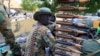 FILE - A South Sudan army soldier stands next to a machine gun mounted on a truck in Malakal town, some 500 km (312 miles) northeast of the capital, Juba, Dec. 30, 2013. South Sudan has been found to be among the countries cutting back on military spending due to low oil prices.
