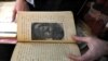A member of the Kurdistan Centre for Arts and Culture, inspects an old book before making a digital copy, as part of an effort to digitize historic Kurdish volumes and manuscripts, in the northern Iraqi city of Dohuk on February 13, 2024.