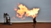 FILE - A flare burns natural gas at an oil well Aug. 26, 2021, in Watford City, N.D.