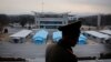 FILE - North Korean People's Army Lt. Col. Nam Dong Ho is silhouetted against the truce village of Panmunjom at the Demilitarized Zone (DMZ) which separates the two Koreas on Monday, Feb. 22, 2016. Critics say a confrontational approach to North Korean provocations has fueled regional tensions.