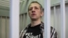 Russian journalist Roman Ivanov, wearing a T-shirt that reads "No war," stands inside a defendant's cage after being sentenced to seven years in prison for criticizing the Ukrainian offensive in social media posts, in Korolyov, Russia, on March 6, 2024.