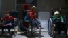 FILE - Children wait to be examined from Unicef health workers in Kafra Batna in the Damascus suburb of eastern Ghouta, Syria, Oct. 30, 2017. 