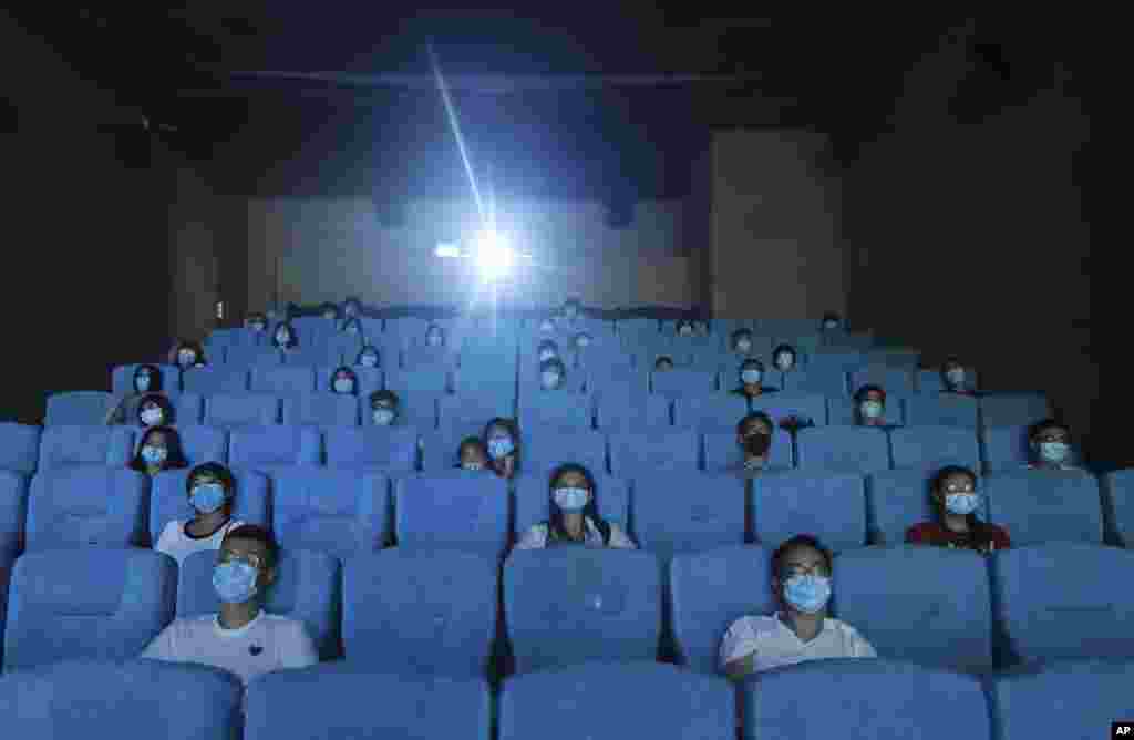 Movie-goers are spaced apart as they watch a movie in a newly reopened cinema in Hangzhou in eastern China&#39;s Zhejiang province.