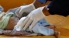A nurse checks a boy at a cholera treatment center at the al-Sabeen hospital in Sanaa, Yemen, Oct. 3, 2018. 